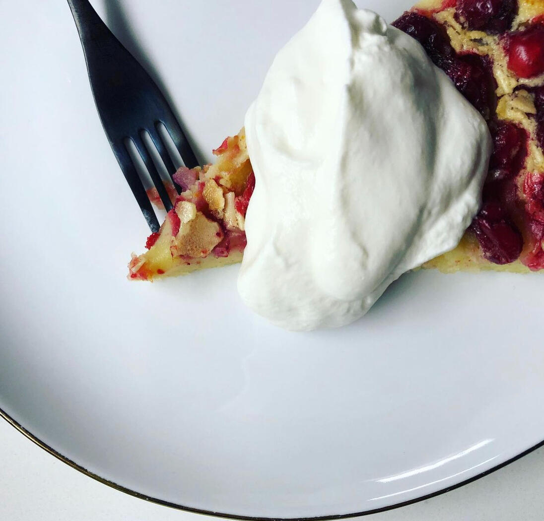 clafoutis slice, fork and chantilly